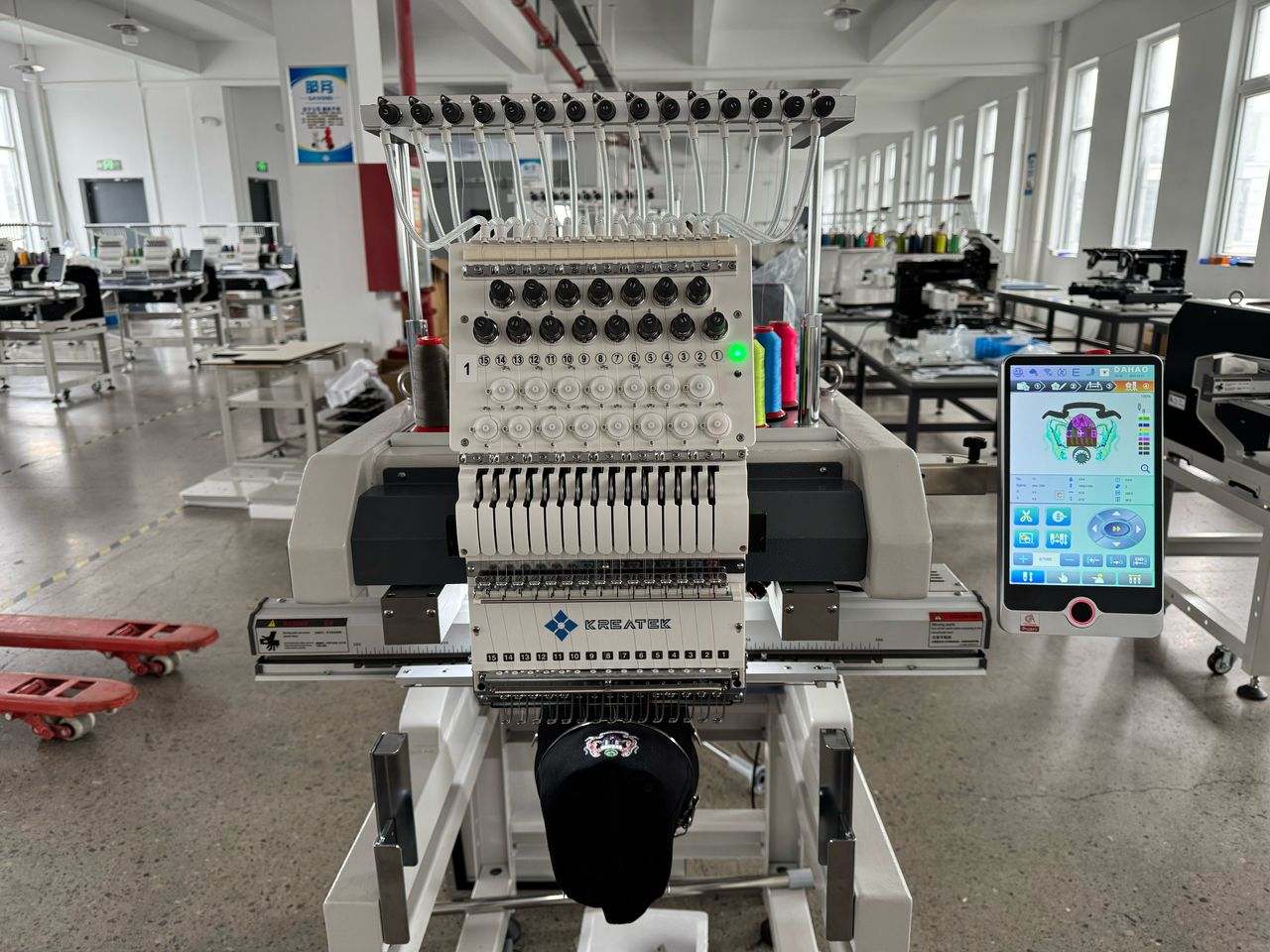 Kreatek III BL-1501 industrial embroidery machine with 15 needles and digital control screen, designed for high-speed cap and textile embroidery.
