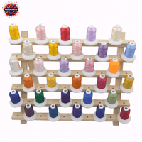 YIGAO embroidery thread set with 63 vibrant polyester colors on a wooden rack for durable and flexible stitching projects.