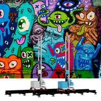 Veggprinter All-in-One wall printer printing colorful monster graffiti on a brick wall with foldable rail structure and compact design