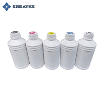 Bottles of Kreatek DTF-blekk in CMYK and white colors for digital textile printing.