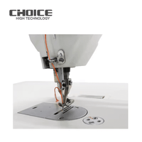 Close-up of Industrisymaskin GC0303 Walkingfoot sewing machine needle and presser foot with orange thread on white base