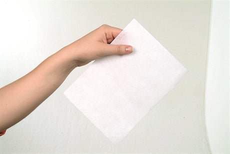 Madeira 9436 Tear Away stabilizer cotton soft white sheet held by hand for embroidery support