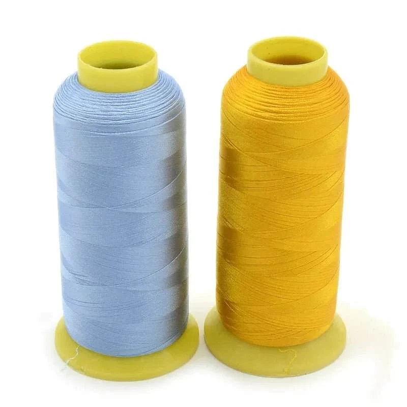 Two spools of Flores polyester embroidery thread in light blue and yellow from a 100-color thread pack, ideal for machine embroidery with vibrant, durable, and high-strength threads.