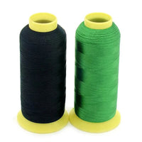 Two spools of Flores polyester embroidery thread in black and green from the trådpakke med 100 farger set