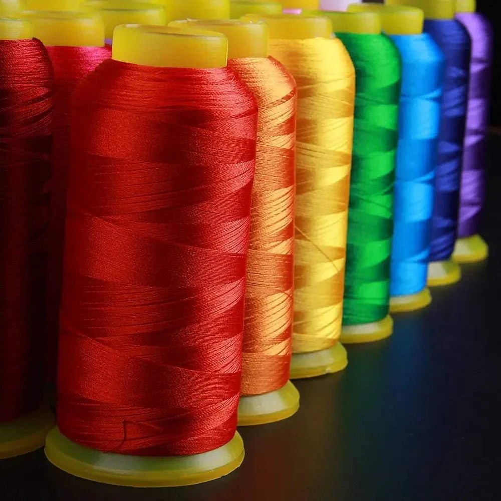 Colorful polyester embroidery thread spools in red, orange, yellow, green, and blue for vibrant machine embroidery projects.