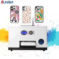 Sunika SK-A3C Printer with UV technology printing colorful custom designs on mobile phone cases including abstract, floral, and vegetable patterns.